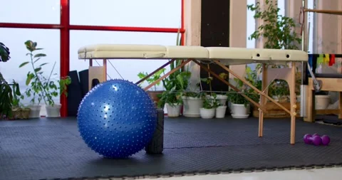 Camera is widening, revealing blue spiky exercise ball shifting left and 스톡 동영상 342032748