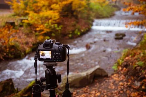 The camera without person is aimed at the forest waterfall 写真素材