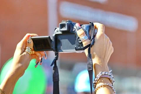 Camera in women's hands Stock Photos
