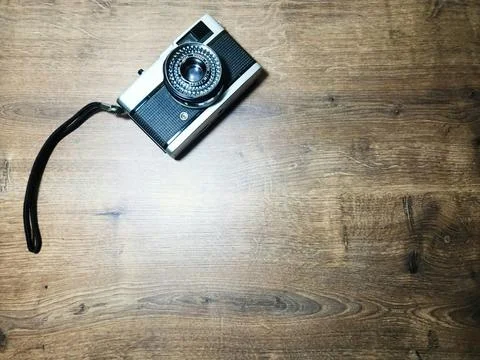 Camera on wooden table Stock Photos