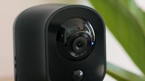 The camera works by planning and scanning to detect at home. Home security and Video stock 321456284