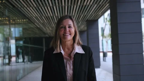 Camera zoom middle-aged Caucasian formal business woman looking smiling at Stock Footage 276314434