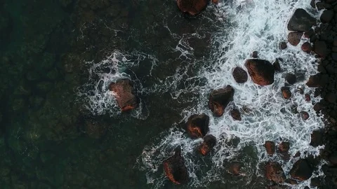 Camera zoom on rocks washed up by ocean waves on sunset in Mauritius. Video stock 83992440