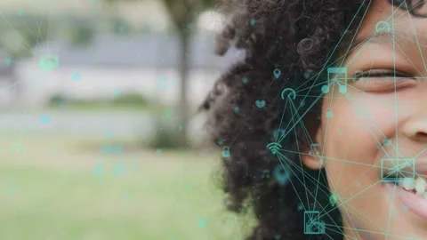 Camera zooming on smiling boy, tech overlay growing into icon mesh over cheek, Stock Footage 334322159