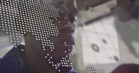 Camera zooming, tech testing part for repair in tech lab while dotted map-code Stock Footage 331026989