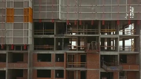 The camera zooms down along a standing building with empty ceilings made of Stock Footage 155477108