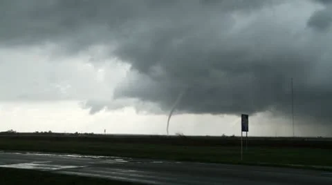 Camera zooms in to slender tornado under a supercell thunderstorm. Stock Footage 11436093