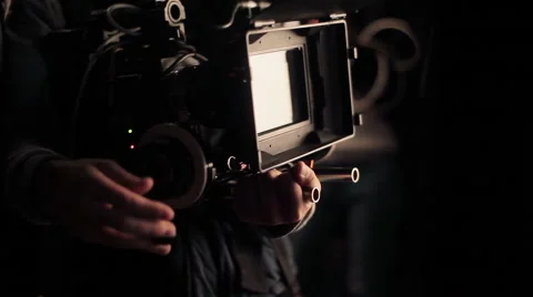 Cameraman adjusting camera before filming. Shooting with red camera. Close-up Stock Footage