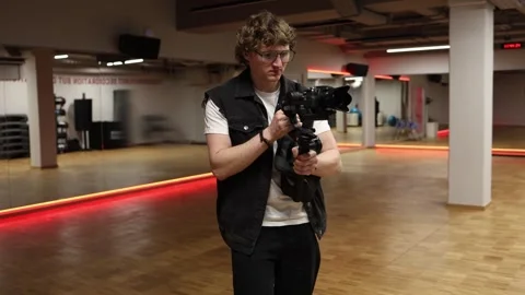 Cameraman adjusting camera settings Stock Footage 332116821