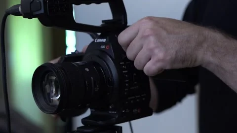 Cameraman Adjusts Camera Stock Footage 170804469