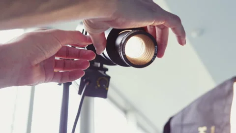 Cameraman adjusts spotlight and prepares recording Stock Footage 231215693