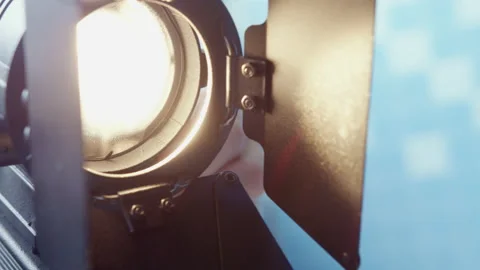 Cameraman adjusts spotlight for better quality shooting Stock Footage 228779856