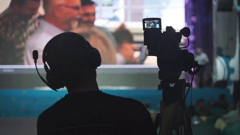 Cameraman with camera on stage at conference Stock-Footage 69753769