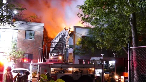 Cameraman at fire scene with firefighters preparing Stock Footage 116085818