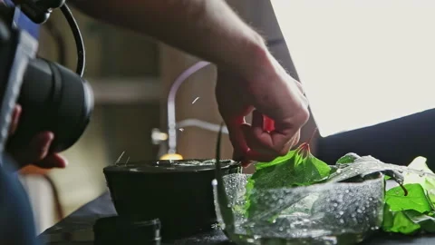 Cameraman fixes green leaf in water and records footage Stock Footage 231215587