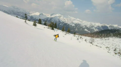 Cameraman following skier through forest Stock Footage