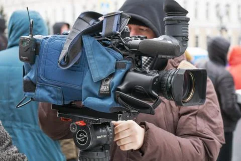 Cameraman with his camera packed in case on the Nemtsov memory march in Moscow Stock Photos