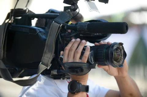 Cameraman holding camera during interview on the street. Stock-Fotos