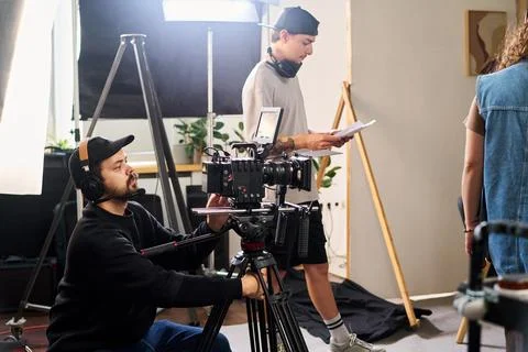 Cameraman Operating Cinema Camera on Set during Video Shoot Stock Photos