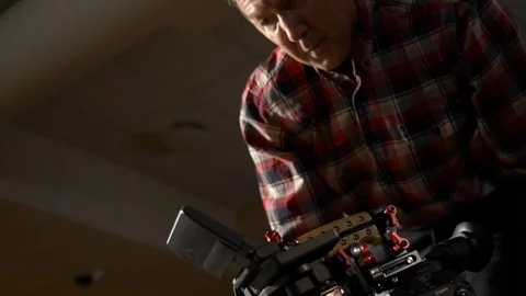 Cameraman operating an EOS Canon C300 Mark II video camera on video production. Stock Footage 99426473