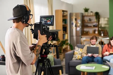 Cameraman Operating Professional Video Camera on Film Set Stock Photos