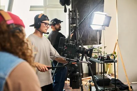 Cameraman Operating Professional Video Camera on Studio Set Stock Photos