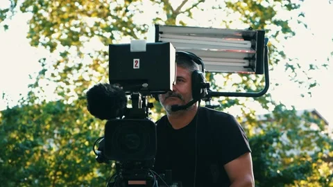 Cameraman in process of work in outdoor studio Stock Footage 159800233