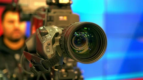 Cameraman in process of work in studio. Camera Lens Stock Footage 119151957