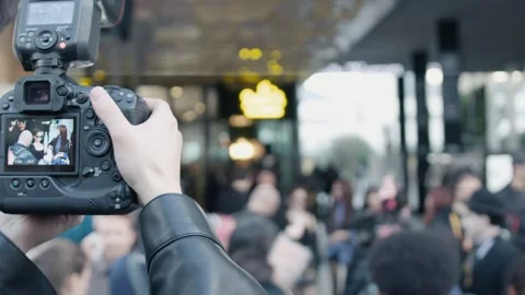 Cameraman recording interview in a crowd Stock Footage 306461430