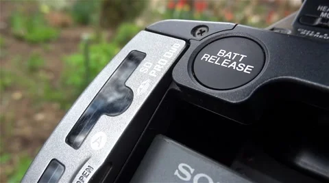 Cameraman remove and reinsert a card in a video camera Stock Footage 58815873