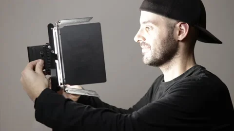 Cameraman is setting up lights on set. Bright led for interview or program Stock Footage 148658266