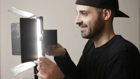 Cameraman is setting up lights on set Video stock 148658262