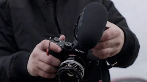 Cameraman is setting mirrorless camera before the set Stock Footage 124118550
