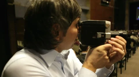 Cameraman Shooting on 8mm camera Stock Footage 10792276