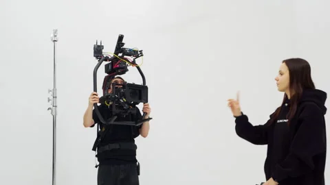 Cameraman tests professional steadicam with assistant Vídeo Stock 308952140