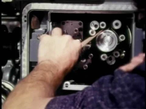 Cameraman threading film through movie camera Stock Footage 260255306