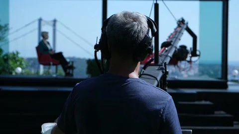 A cameraman uses a camera jib on a television show featuring Stock Footage 158656708