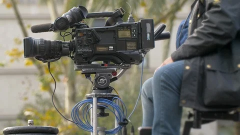 Cameraman using a professional and old TV camera Stock Footage 99137334