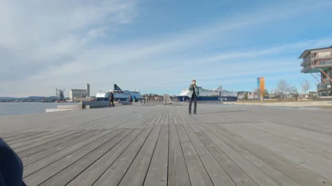 Cameraman walking backwards while filming at Sorenga Sjobad 库存影片 340959558