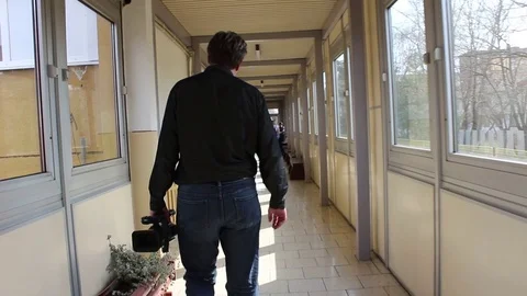 Cameraman walking with camera Stock Footage 76036785