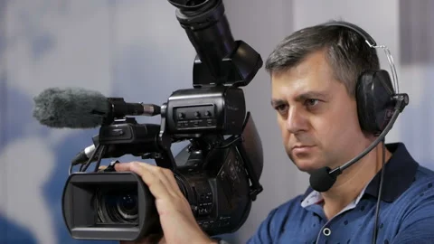 The cameraman is working behind the camera. Stock-Footage 94815478
