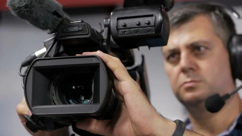 The cameraman is working behind the camera. Stock-Footage 94815488