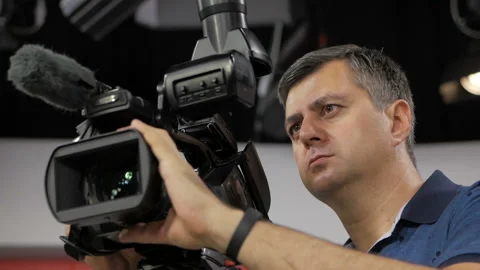 The cameraman is working behind the camera. Stock-Footage 94816732
