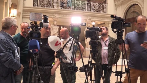Cameramen people and tripods before a press conference, Journalists media Video stock 89601853