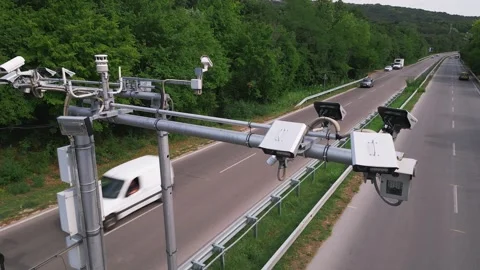 Cameras and speed control radars along a busy highway monitor and record Stock Footage 247138479