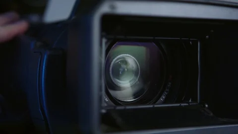 Camerman recording with video camera and changing focal lenght of the lens Stock Footage 127612753