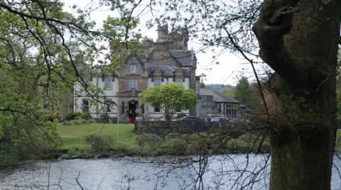Cameron house Scottish Castle through a tree wide shot Stock Footage 60414774
