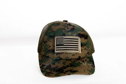 A camouflage hat with an American flag patch Stock Photos