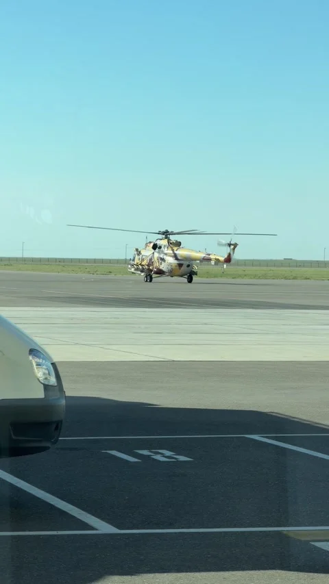 A camouflaged Mi-8 (Mi-17) military helicopter slowly moves along the runway Stock Footage 335352176