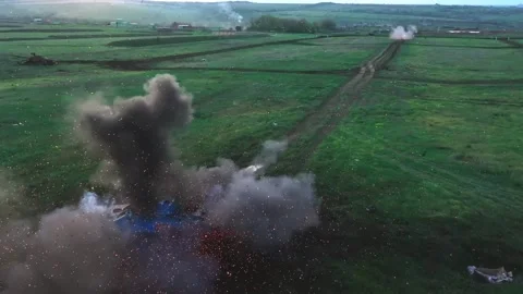Camouflaged tank firing and exploding on a rural test field Stock Footage 313255480
